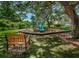 Playground featuring play equipment, set within a safe, mulched area with surrounding bench at 2690 Coral Landings Blvd # 722, Palm Harbor, FL 34684