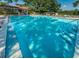Sparkling community pool with ample lounge chairs, providing residents with a refreshing and relaxing oasis at 2690 Coral Landings Blvd # 722, Palm Harbor, FL 34684
