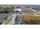 Aerial view of a residential community with houses and a lake at 8852 Prairie Creek Dr, New Port Richey, FL 34655