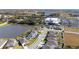Aerial image showcasing a neighborhood near a lake and shopping center at 8852 Prairie Creek Dr, New Port Richey, FL 34655