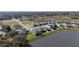 Aerial view of homes near lake in community at 8852 Prairie Creek Dr, New Port Richey, FL 34655