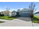 Single-story home with two-car garage and landscaped yard at 8852 Prairie Creek Dr, New Port Richey, FL 34655