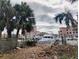 Disturbed lot with debris near boats and waterfront at 113 Boca Ciega Dr, Madeira Beach, FL 33708