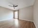 Light and airy bedroom featuring wood-look floors and window with blinds at 1333 Shady Pine Way # D, Tarpon Springs, FL 34688