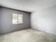 Bright bedroom with window, carpet, and double closets at 3713 Champagne Dr # 115, Tampa, FL 33618