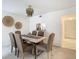 Dining area with wood table, brown chairs, and chandelier at 3713 Champagne Dr # 115, Tampa, FL 33618