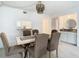 Dining room featuring a wood table and six brown chairs at 3713 Champagne Dr # 115, Tampa, FL 33618