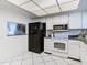 Modern kitchen with stainless steel appliances and white cabinetry at 3713 Champagne Dr # 115, Tampa, FL 33618