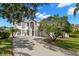 Two-story house with a three-car garage and manicured lawn at 4915 Augusta Ave, Oldsmar, FL 34677