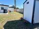 Backyard with storage shed, green grass, flower planters, and a wood fence at 9322 88Th Way, Seminole, FL 33777