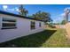 Side of home with a wooden fence and some grass at 9322 88Th Way, Seminole, FL 33777