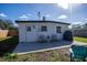 Rear exterior view of the home with a patio area, outdoor seating, and a grill at 9322 88Th Way, Seminole, FL 33777