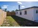 A fenced backyard with a white home that has black window trim and a dark roof at 9322 88Th Way, Seminole, FL 33777