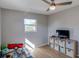 Comfortable bedroom featuring wood floor, storage unit, and a sunlit window at 9322 88Th Way, Seminole, FL 33777