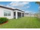 Spacious backyard with grassy lawn and screened porch at 10309 Malvasia Ave, Riverview, FL 33578