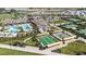 Aerial view of the community recreation area with a pool, tennis courts, and bocce ball courts at 31803 Cardinal Yard Dr, San Antonio, FL 33576