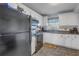 Modern kitchen with white cabinets and black appliances at 4650 Cove Cir # 304, St Petersburg, FL 33708