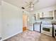 White kitchen appliances and cabinets, view of hallway at 1003 W River Heights Ave, Tampa, FL 33603