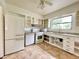 Bright kitchen features white appliances and ample cabinetry at 1003 W River Heights Ave, Tampa, FL 33603