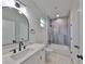 Modern bathroom with marble vanity, gray tile shower, and updated fixtures at 1906 Cherry W St # 1, Tampa, FL 33607