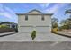 Two-car garage, new construction home with a modern facade and spacious driveway at 1906 Cherry W St # 1, Tampa, FL 33607