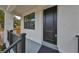 Modern front door with black finish and sidelights, welcoming porch at 1906 Cherry W St # 1, Tampa, FL 33607