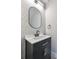 Modern powder room with black vanity and geometric wallpaper at 1906 Cherry W St # 1, Tampa, FL 33607