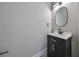 Modern bathroom with a black vanity and geometric wallpaper at 1906 Cherry W St # 2, Tampa, FL 33607