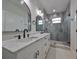 Elegant bathroom with double vanity, marble countertop, and walk-in shower at 1906 Cherry W St # 2, Tampa, FL 33607