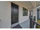 Contemporary black front door with a gray porch and black railing at 1906 Cherry W St # 2, Tampa, FL 33607