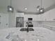 Modern kitchen island with marble countertop and a stainless steel sink at 1906 Cherry W St # 2, Tampa, FL 33607