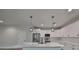 Modern kitchen with white cabinets, marble island, and pendant lighting at 1906 Cherry W St # 2, Tampa, FL 33607