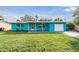 Charming ranch home with turquoise exterior, attached garage, and spacious lawn at 2315 Nash St, Clearwater, FL 33765