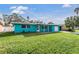 Charming Ranch style home with teal exterior and lush lawn at 2315 Nash St, Clearwater, FL 33765