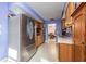 Stainless steel refrigerator in a galley kitchen with wood cabinets and purple walls at 2315 Nash St, Clearwater, FL 33765