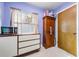 Kitchen area with wood cabinet and a window with curtains at 2315 Nash St, Clearwater, FL 33765