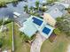 Beautiful aerial view of waterfront home featuring solar panels and a screened-in pool at 1104 Kingfish Pl, Apollo Beach, FL 33572