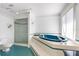 Bright bathroom featuring a soaking tub, glass-enclosed shower, and tiled floor at 1104 Kingfish Pl, Apollo Beach, FL 33572