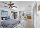 Staged bedroom featuring a ceiling fan and access to the outdoor balcony at 1104 Kingfish Pl, Apollo Beach, FL 33572