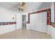 bedroom featuring a ceiling fan, closet with louvered doors, and colorful wallpaper at 1104 Kingfish Pl, Apollo Beach, FL 33572