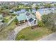 Aerial view of a charming home with solar panels, a well-manicured lawn, and a circular driveway at 1104 Kingfish Pl, Apollo Beach, FL 33572