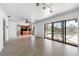 Bright living room with sliding glass doors overlooking the pool and a view into the kitchen at 1104 Kingfish Pl, Apollo Beach, FL 33572