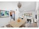 Open-concept living and dining area with modern decor, adjacent to a kitchen with stainless steel appliances at 1104 Kingfish Pl, Apollo Beach, FL 33572