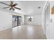 Light-filled living room featuring a ceiling fan and access to the outdoor balcony at 1104 Kingfish Pl, Apollo Beach, FL 33572