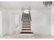 Open staircase with dark wood treads and white risers, bright and airy at 1104 Kingfish Pl, Apollo Beach, FL 33572