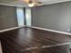 Large bedroom with dark laminate flooring and gray walls at 11933 72Nd Ave, Seminole, FL 33772