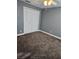 Bedroom with gray walls, ceiling fan, and wall-to-wall carpeting, featuring double doors to closet at 11933 72Nd Ave, Seminole, FL 33772