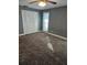 Bedroom with gray walls, ceiling fan, and carpeting; features double doors to closet at 11933 72Nd Ave, Seminole, FL 33772