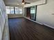 Sunroom featuring dark laminate flooring and sliding glass doors at 11933 72Nd Ave, Seminole, FL 33772