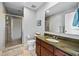 Bathroom featuring a glass-enclosed shower, granite countertop, and modern fixtures at 1209 E Cumberland Ave # 508, Tampa, FL 33602